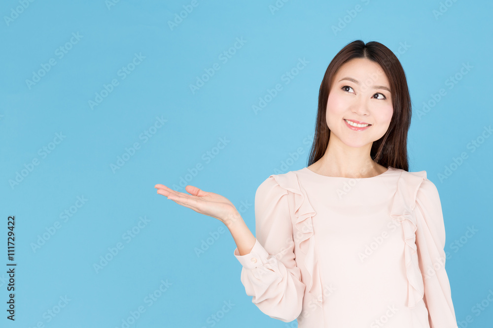 portrait of asian woman showing isolated on blue background portrait of asian woman showing isolated on blue background
