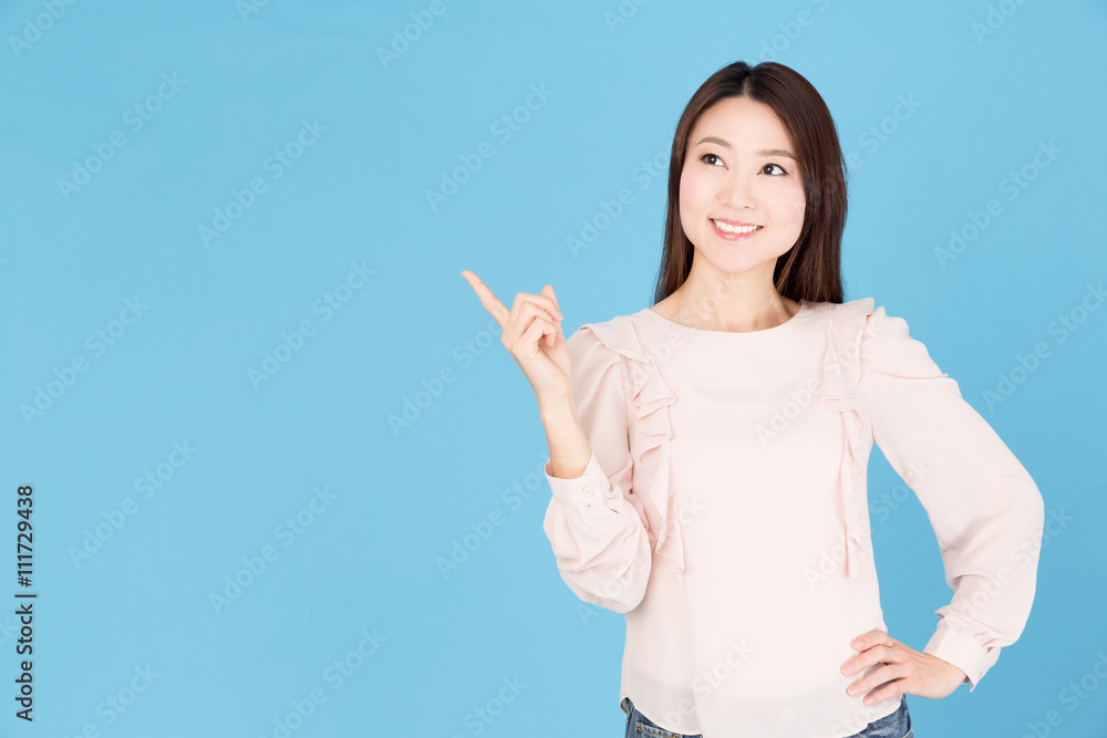 portrait of asian woman showing isolated on blue background portrait of asian woman showing isolated on blue background