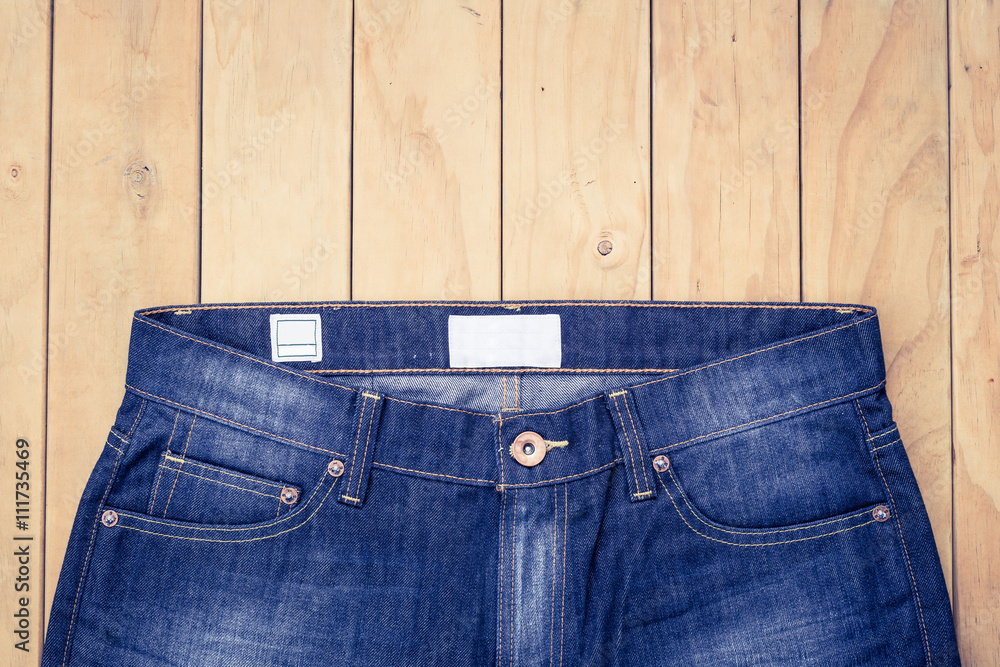 Blue jeans on wooden background top view Blue jeans on wooden background top view