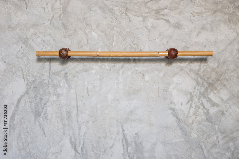 Bamboo towel hanger on grey cement wall Bamboo towel hanger on grey cement wall