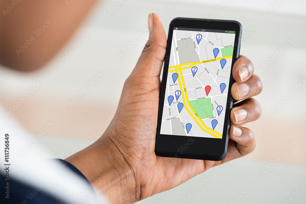 Woman's Hand Holding Mobile Phone With Location Mark On Map