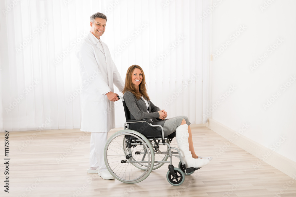 Doctor Assisting Woman On Wheelchair Doctor Assisting Woman On Wheelchair