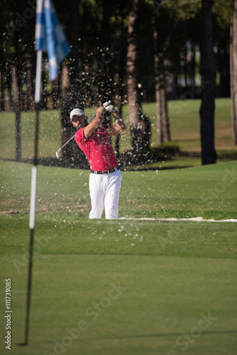 golfer hitting a sand bunker shot © .shock