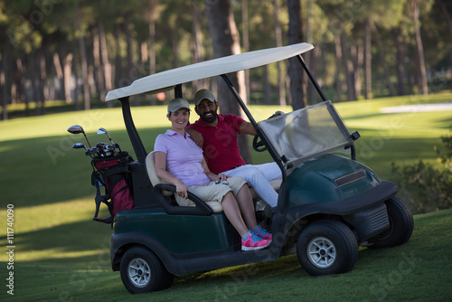 couple in buggy on golf course