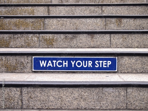 Watch your step sign on a staircase