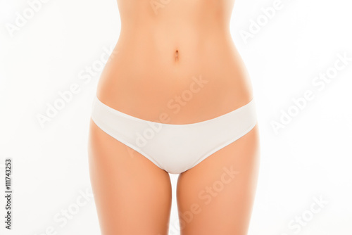 Close up photo of attractive white woman's panties and slim stom