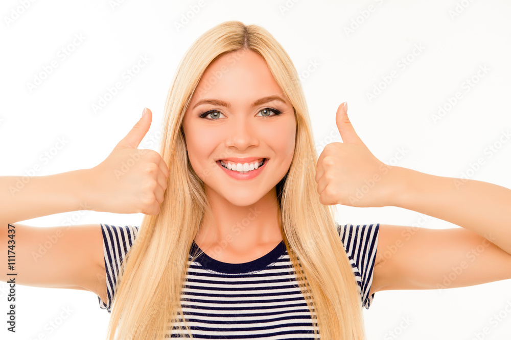 Attractive blonde with beaming smile showing thumbs up Attractive blonde with beaming smile showing thumbs up