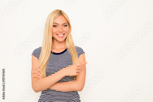Portrait of cheerful young woman gesturing and showing way © deagreez