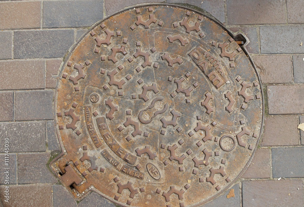 Kaliningrad, Russia - June 21, 2010: Retro manhole cover on asphalt in Kaliningrad, Russia