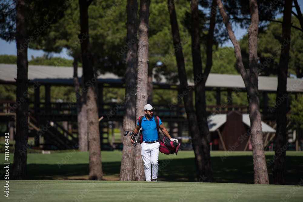 golf player walking and carrying bag golf player walking and carrying bag