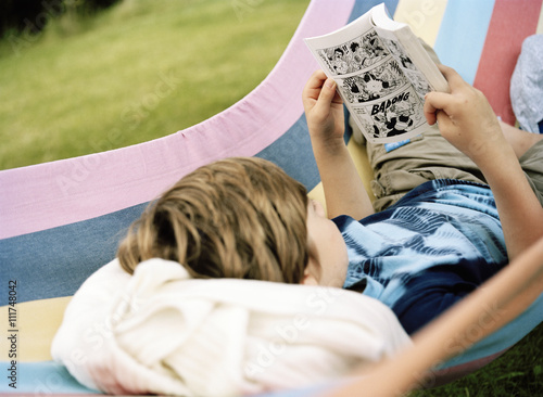 A boy reading a comic.