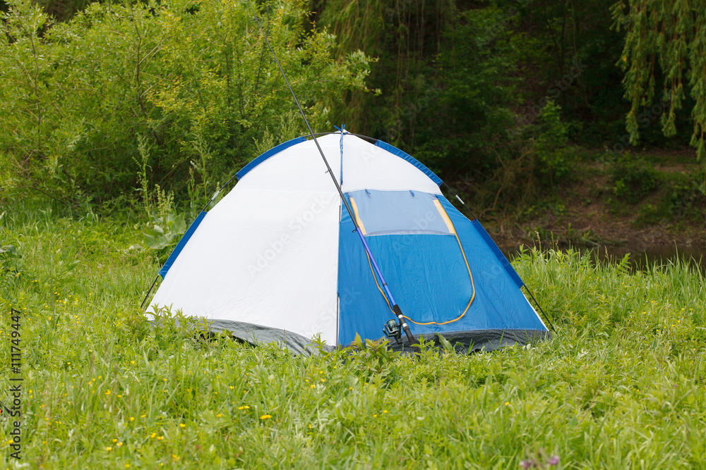 Camp tent and fishing rod on outdoor