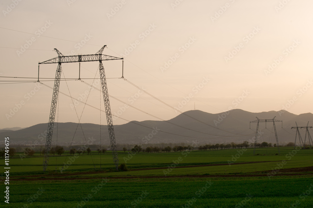 grass field and electric pylon