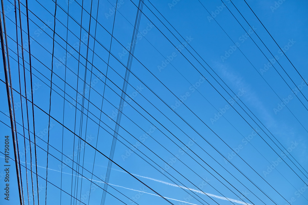 Plurality of electrical wire against the bkue sky