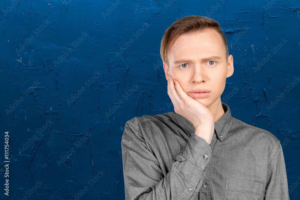 Confused young man thinking Confused young man thinking