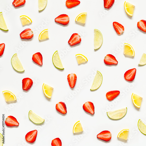 Colorful pattern of strawberries, lime, lemon. Top view of the citrus fruits and sliced strawberries.