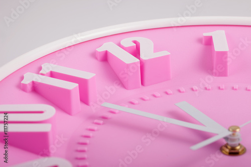 pink clock face or dial closeup