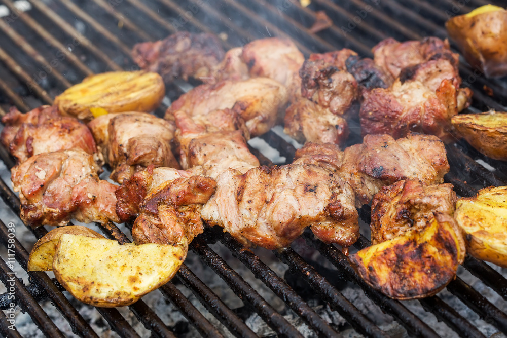 Roasted meat with potatoes on the grill
