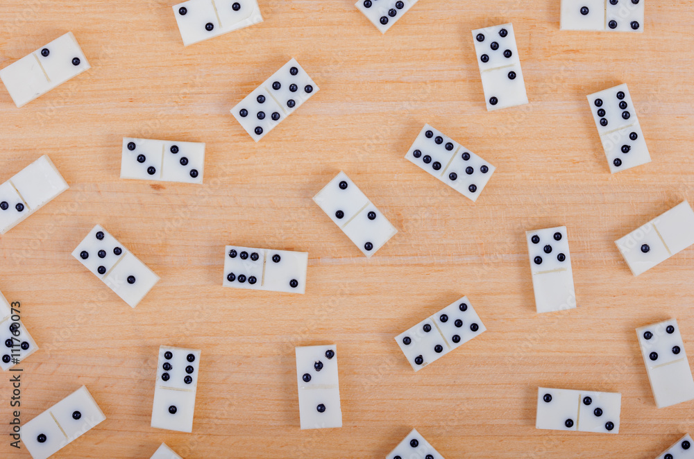 background consists of old dominoes on wooden board background consists of old dominoes on wooden board