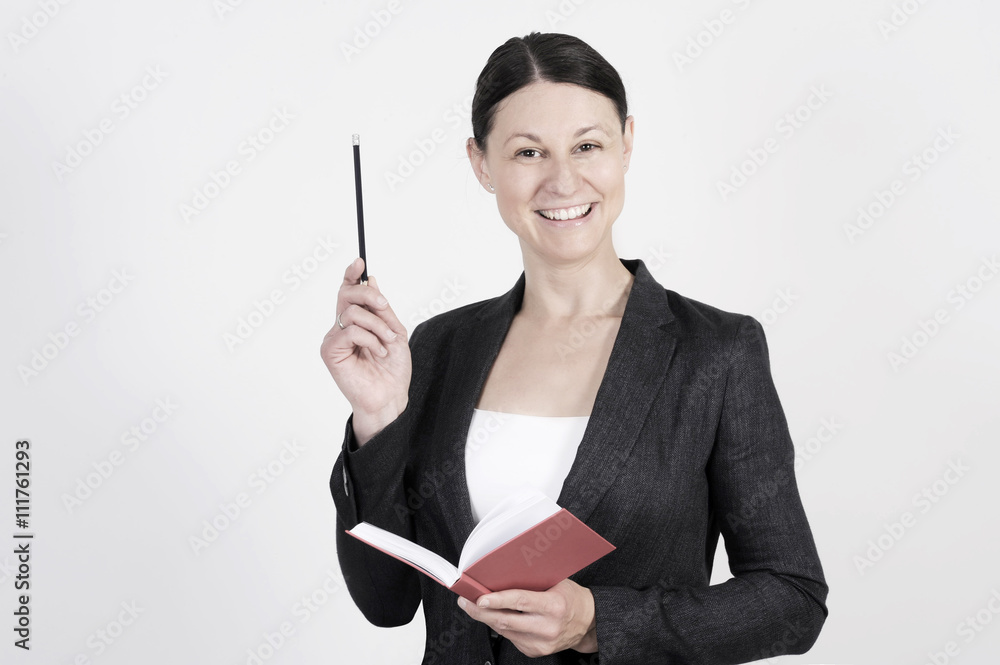 Nice business woman is doing a presentation with pen and notebook in her hand. Nice business woman is doing a presentation with pen and notebook in her hand.