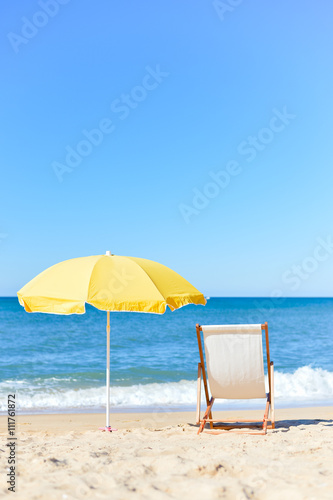 Chair and umbrella on stunning tropical beach background vacation 