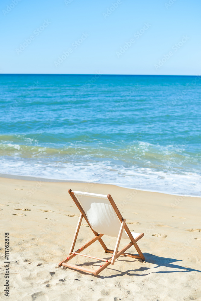 Back View Of Deckchair On Sandy Beach. Back View Of Deckchair On Sandy Beach.