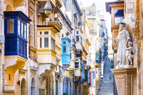 Canvas Print Typical narrow streets with colorful balconies in Valletta , Malta