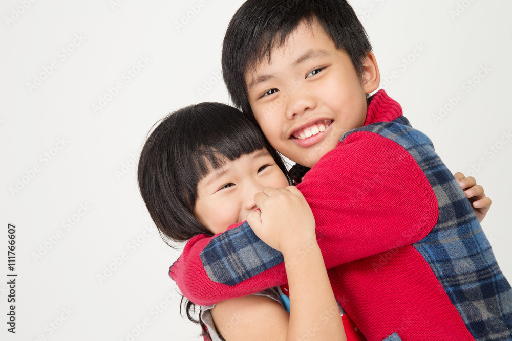 Portrait of asian cute boy hug your sister with smile face