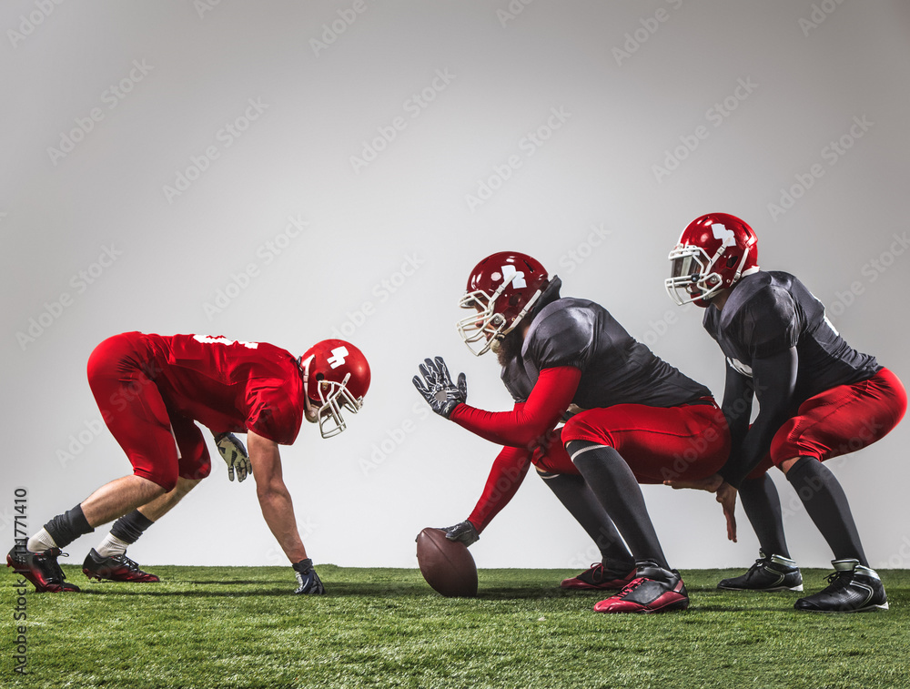 The three american football players in action The three american football players in action