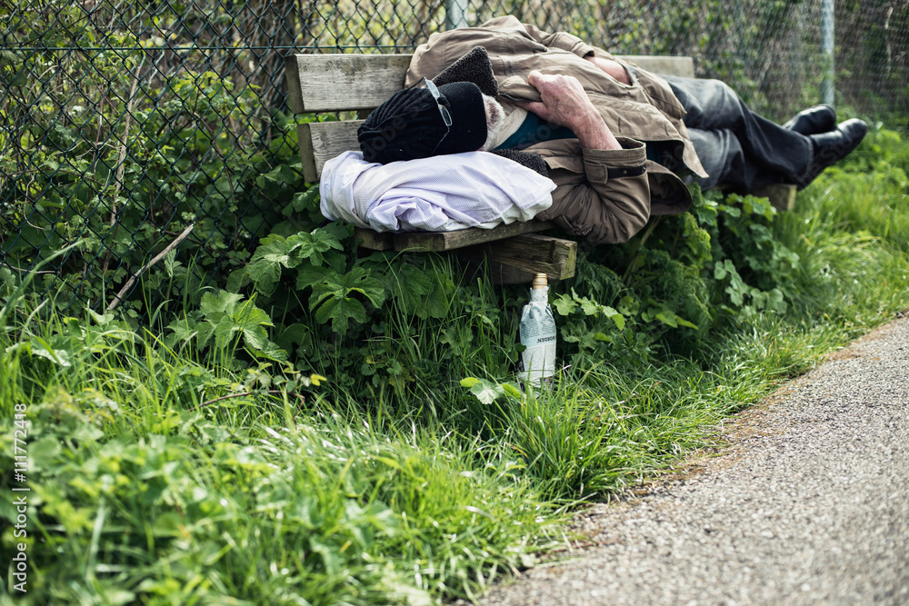 Homeless man sleeping on bench in park. Homeless man sleeping on bench in park.
