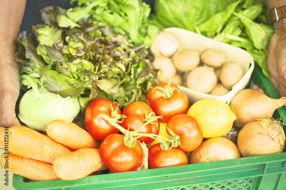 Man holding crate with fresh organic vegetables Man holding crate with fresh organic vegetables