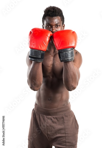 Handsome black man with boxing gloves © luismolinero