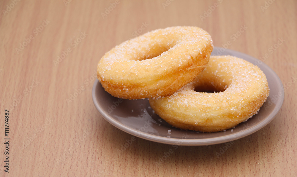 yeast donut with sugar on wooden background yeast donut with sugar on wooden background