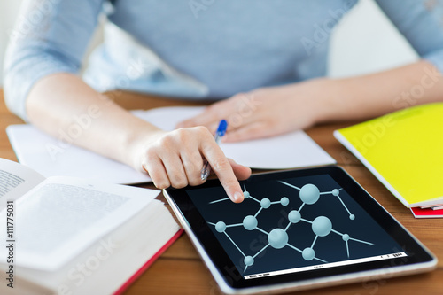 close up of woman with molecule on tablet pc