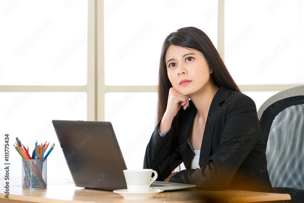 Young Asian businesswoman thinking in the office Young Asian businesswoman thinking in the office