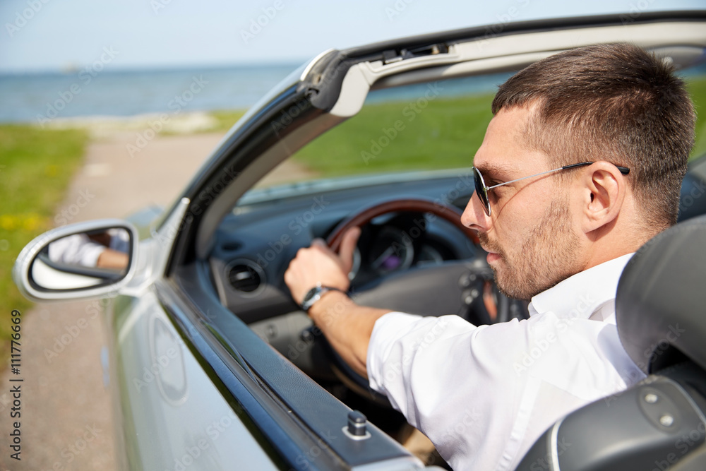 happy man driving cabriolet car outdoors happy man driving cabriolet car outdoors