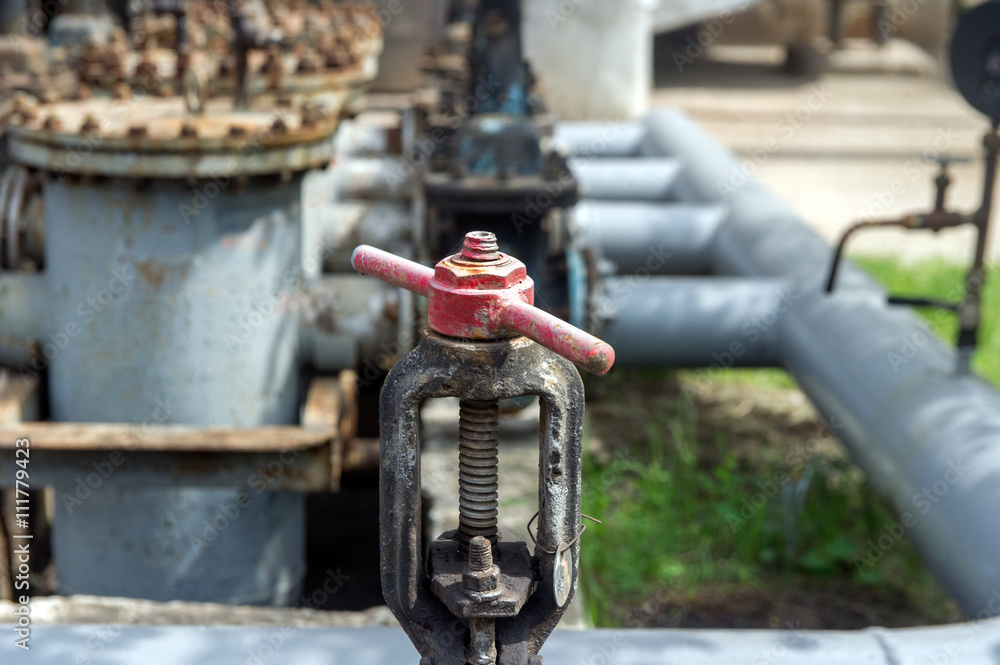 Faucet with steel pipes in natural gas processing plant in summer day Faucet with steel pipes in natural gas processing plant in summer day