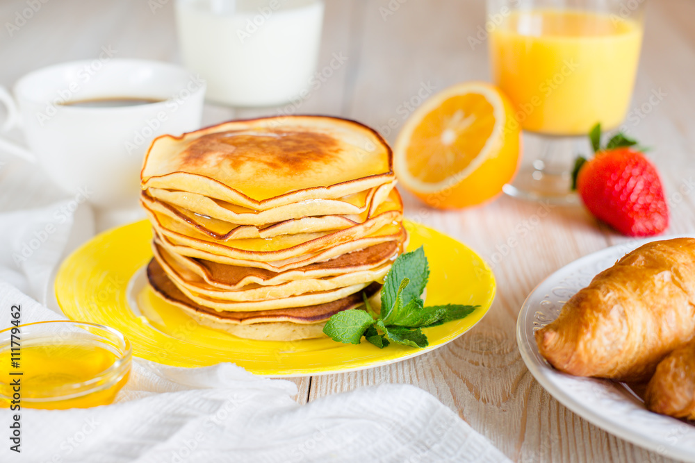 Breakfast with pancakes on a yellow plate Breakfast with pancakes on a yellow plate