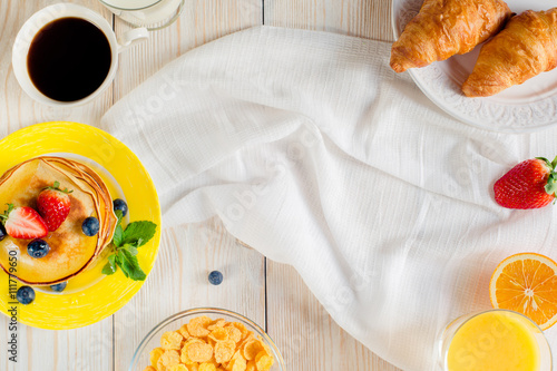 Pancakes on a yellow plate on a white background photo