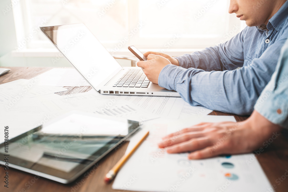 Website developers working using laptop at the office on wooden Website developers working using laptop at the office on wooden