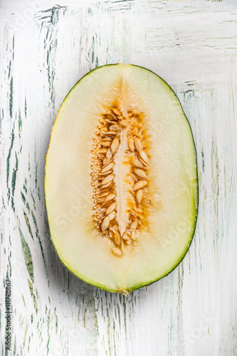 Wallpaper Mural Half of melon with seeds on light rustic background, top view Torontodigital.ca