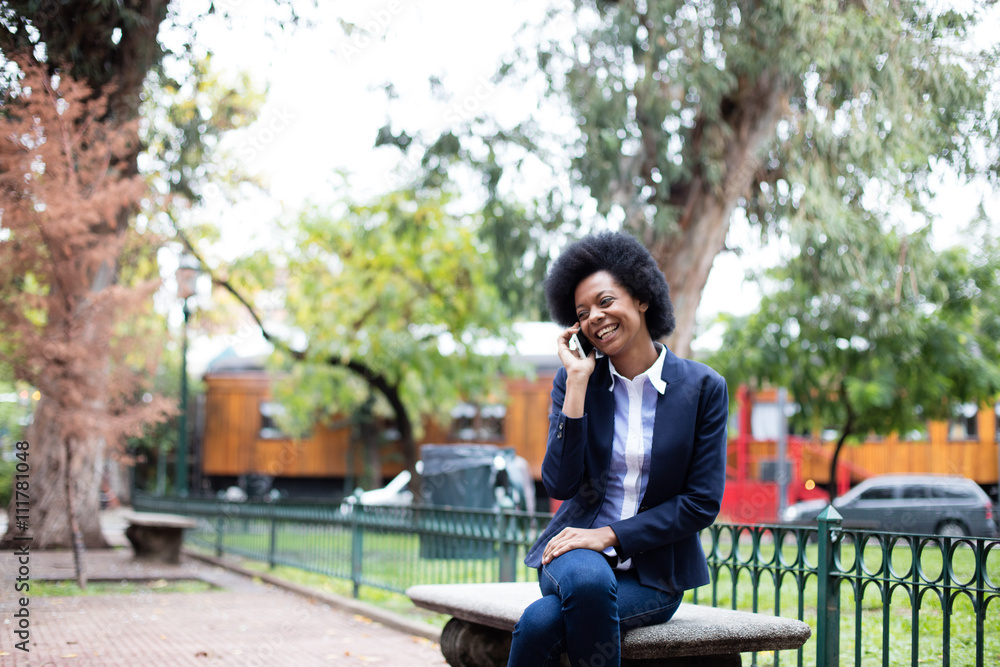 Black woman relaxed, sitting on bench park Black woman relaxed, sitting on bench park