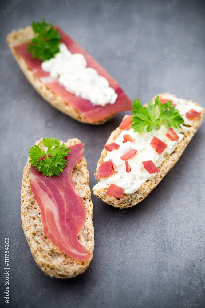 Crispbread with soft cheese with herbs and bacon. Crispbread with soft cheese with herbs and bacon.