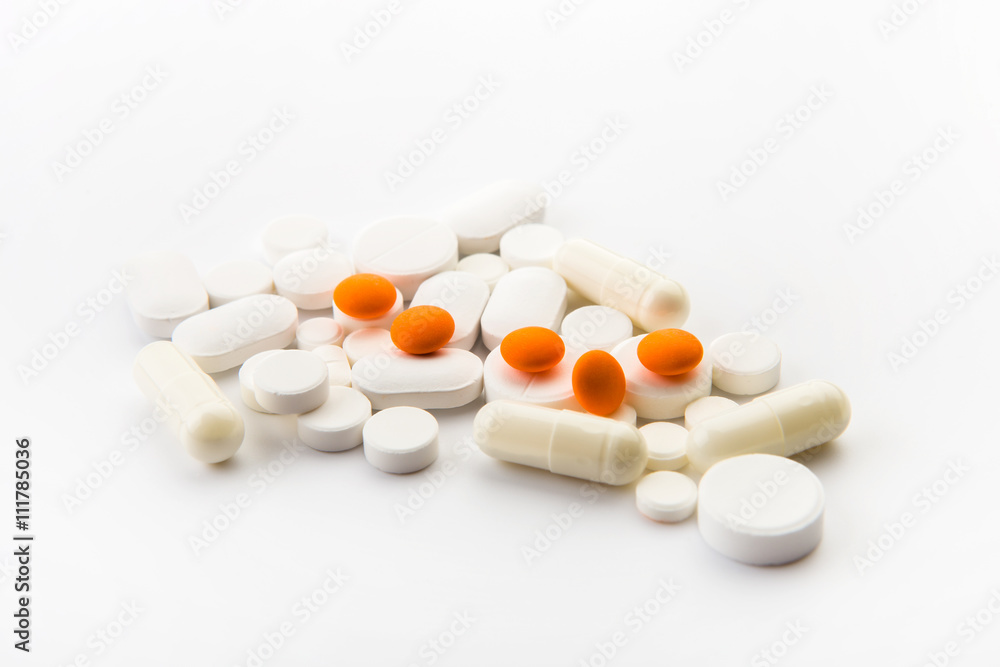 Different colored tablets on a white background close Different colored tablets on a white background close