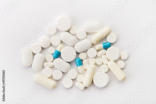 Different colored tablets on a white background close