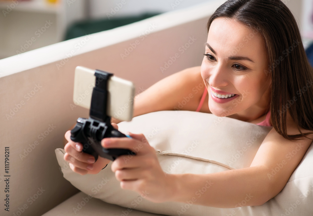 Pleasant beautiful woman using game console Pleasant beautiful woman using game console