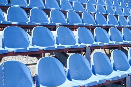 Rows of blue plastic seats in the stadium