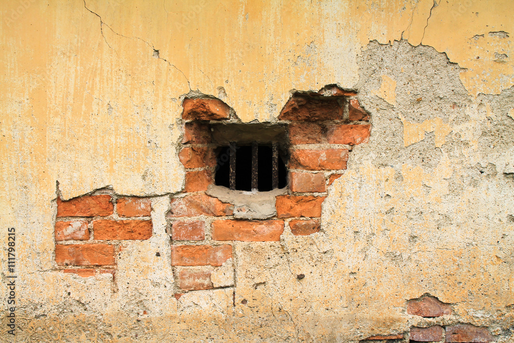 Close up of reinforced brick wall with small grill. Close up of reinforced brick wall with small grill.