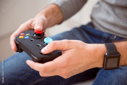 Man holding joystick of game console
