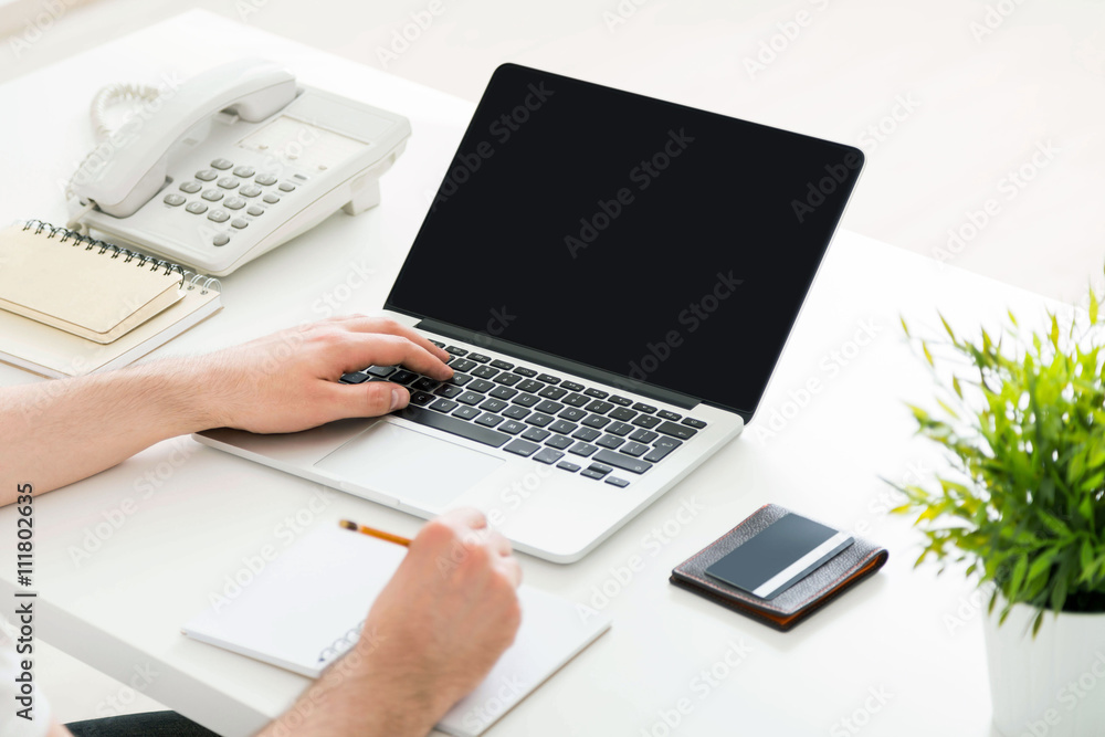 Man keyboarding and writing Man keyboarding and writing